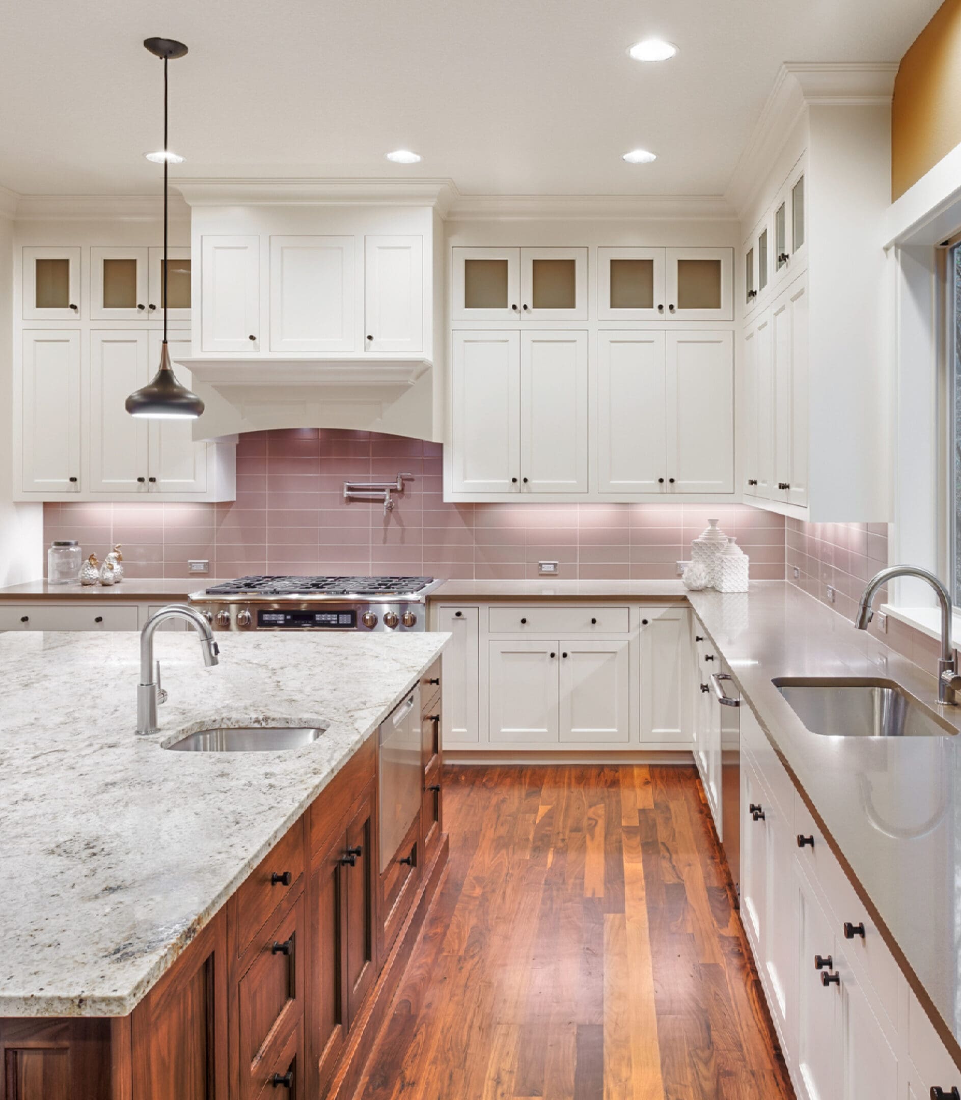 Spacious kitchen interior with dual sinks and stove