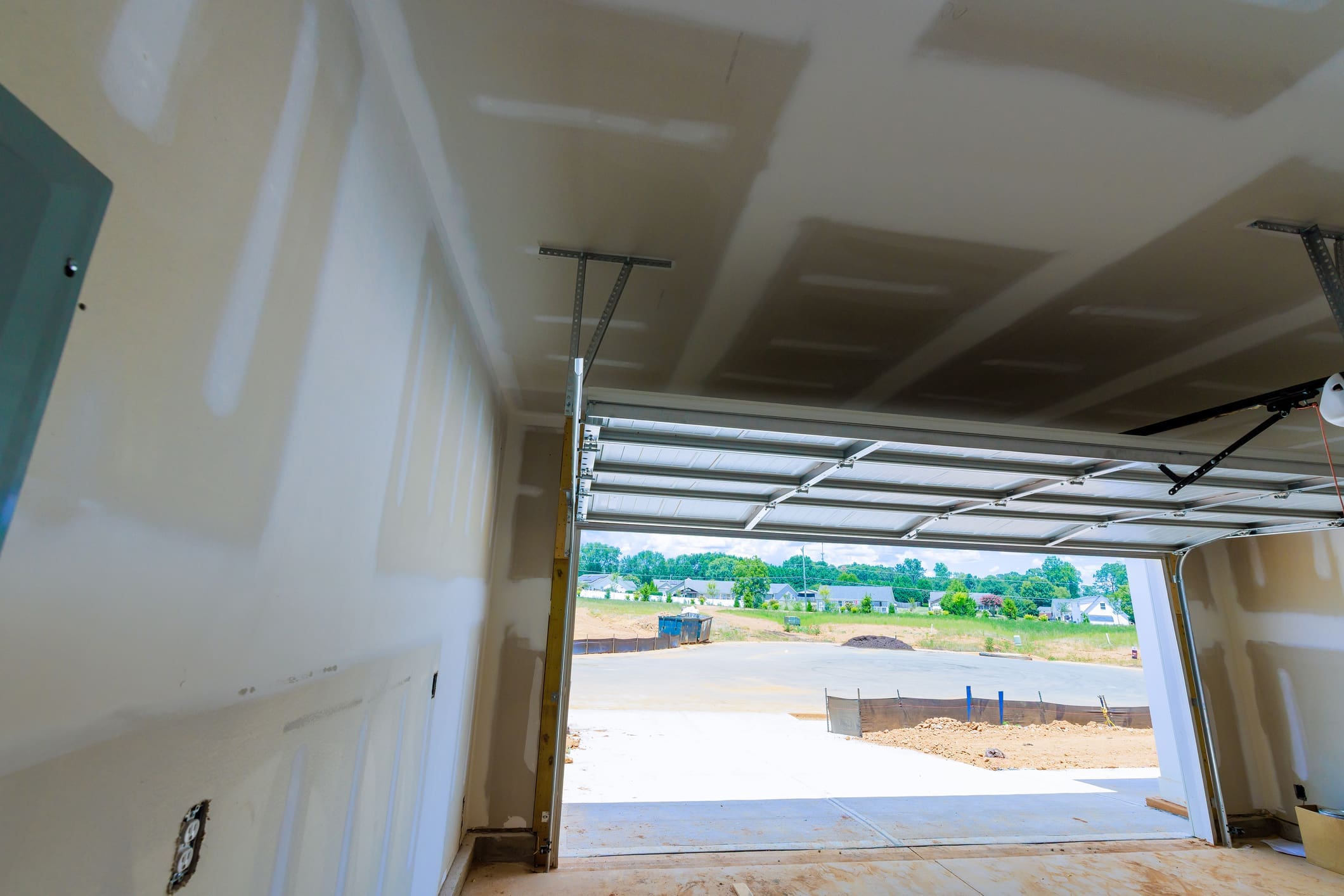 Unfinished garage interior with open door
